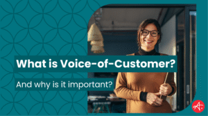 Smiling professional stands confidently in a modern office environment, holding a tablet and representing customer insight and engagement. Text overlay reads: What is Voice-of-Customer? And why is it important?