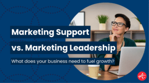 Professional woman sitting at a desk with a laptop, thoughtfully looking upward, alongside headline text reading Marketing Support vs. Marketing Leadership on a dark blue patterned background.
