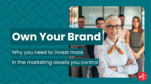 Confident business leader stands with arms crossed in front of a smiling team, symbolizing brand ownership and leadership. Text overlay reads: Own Your Brand – Why you need to invest more in the marketing assets you control.