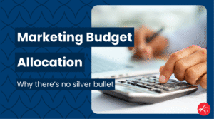 Close-up of a person using a calculator next to a laptop with text overlay reading Marketing Budget Allocation and Why there’s no silver bullet, representing marketing finance and strategy planning.