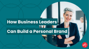 Confident business leader standing with arms crossed in an office environment, symbolizing personal brand development. Text on image reads How Business Leaders Can Build a Personal Brand.