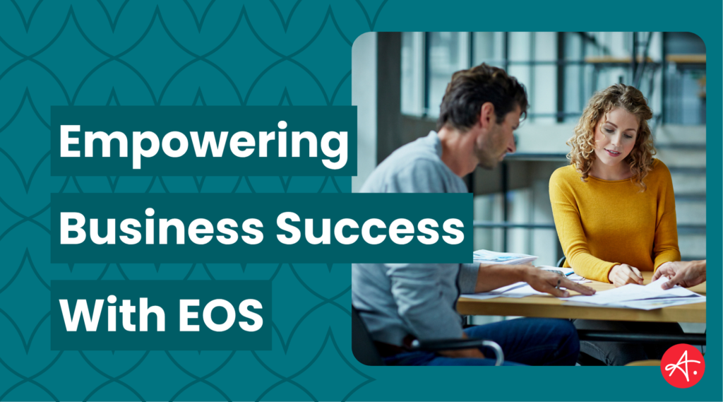 Two professionals having a discussion at a table with documents, alongside text that reads "Empowering Business Success With EOS" on a patterned teal background.