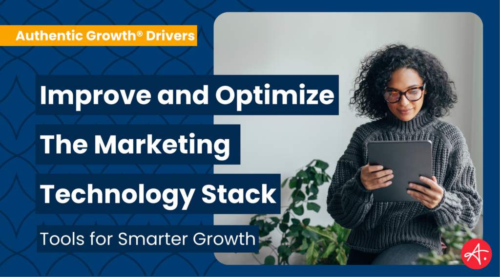 Woman with curly hair and glasses holding a tablet, exploring tools for improving and optimizing the marketing technology stack.
