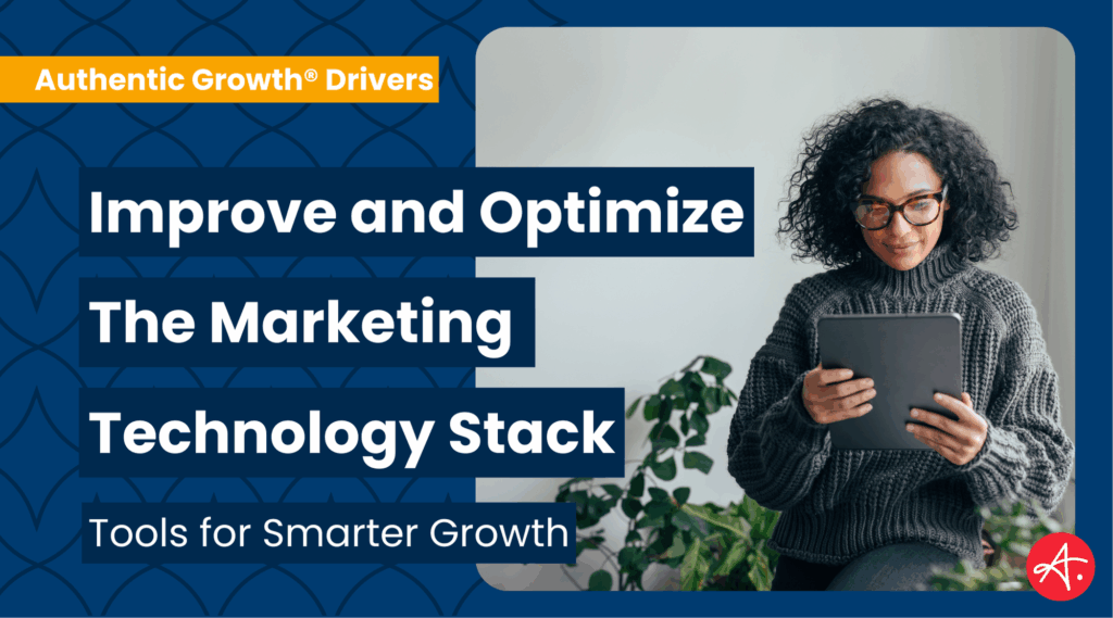 Woman with curly hair and glasses holding a tablet, exploring tools for improving and optimizing the marketing technology stack.