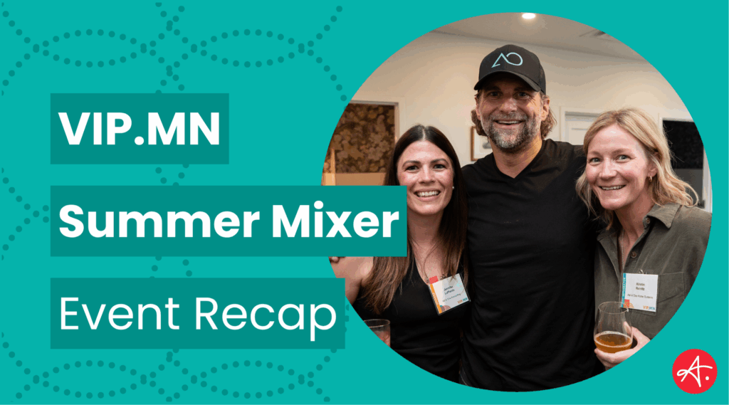 Three smiling attendees at the VIP.MN Summer Mixer pose together for a photo during the event. Two women and one man, all wearing name badges, are enjoying drinks and camaraderie.