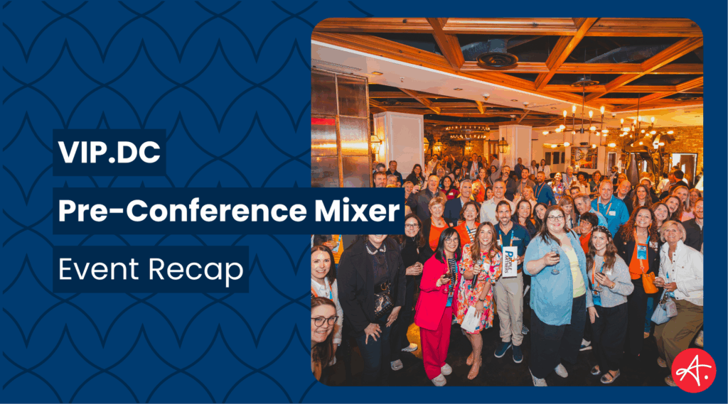 Group photo of attendees smiling and mingling at the VIP.DC Pre-Conference Mixer inside a warmly lit venue, with a crowd of professionals and branded signage from Authentic.